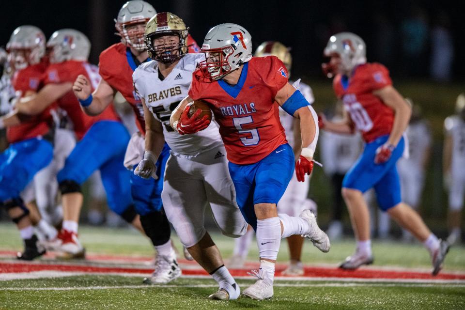 Roncalli High School senior Luke Hansen (5) runs the ball out of the backfield during the second half of an IHSAA Class 4A football sectional championship game against Brebeuf Jesuit Preparatory High School, Friday, Nov. 4, 2022, at Roncalli High School. Roncalli won 21-14.