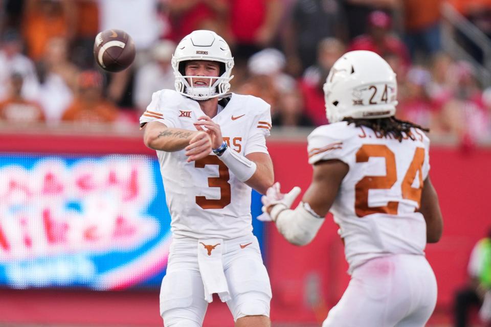 Texas quarterback Quinn Ewers throws to running back Jonathon Brooks during their Oct. 21 win over Houston. Both players rank among the nation's top 100 NIL earners.