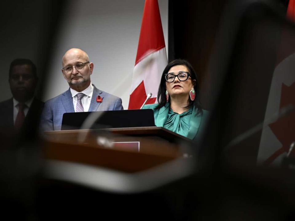 Hilda Anderson-Pyrz, chair of the National Family and Survivors Circle, right, speaks as Minister of Justice David Lametti listens during a funding announcement in Ottawa on May 29, 2023. (Justin Tang/Canadian Press - image credit)