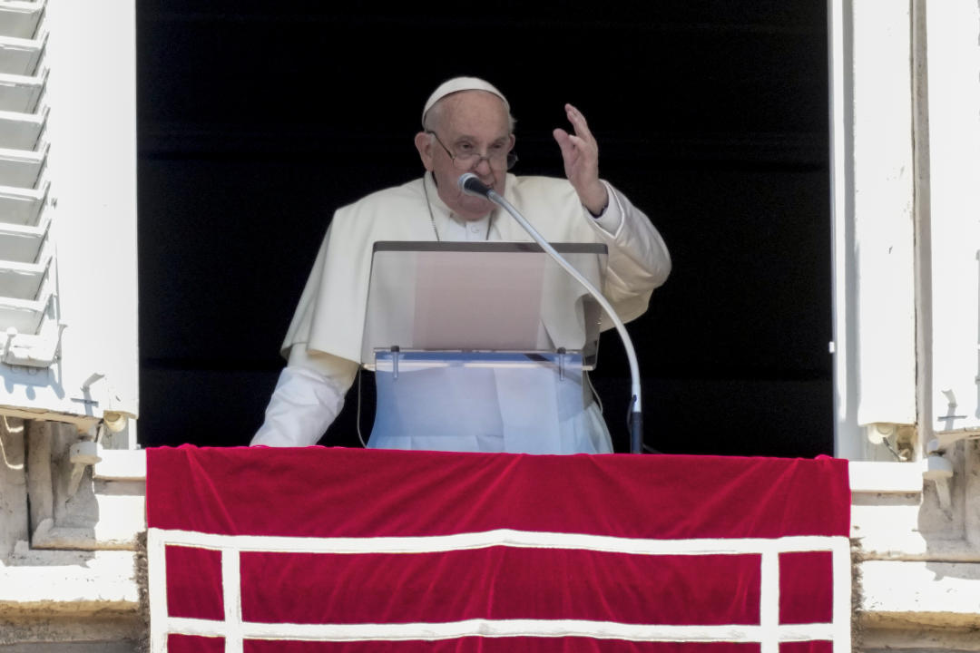 Pope Francis speaks from the window of his studio overlooking St. Peter's Square on April 14