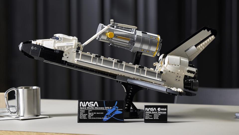 LEGO's Discovery Space Shuttle set on a desk and opened to show its Hubble Telescope