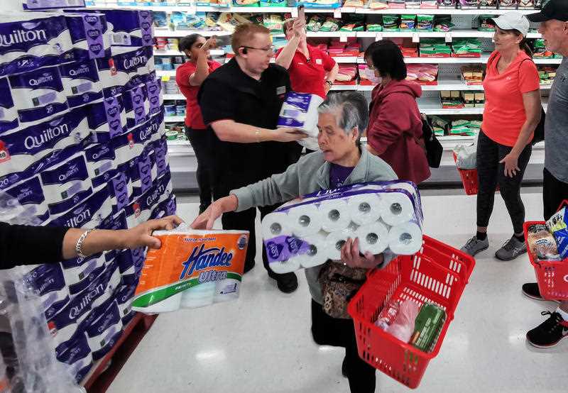 People receiving toilet paper, paper towel and pasta at Coles Supermarket, Epping in Sydney.