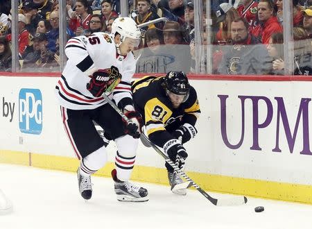 Nov 18, 2017; Pittsburgh, PA, USA; Chicago Blackhawks center Artem Anisimov (15) and Pittsburgh Penguins right wing Phil Kessel (81) fight for the puck during the second period at PPG PAINTS Arena. Mandatory Credit: Charles LeClaire-USA TODAY Sports