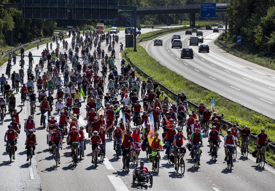 Demonstrators ride their bikes on a highway in Frankfurt, Germany, Saturday, Sept. 14, 2019. About 20,000 cyclists took part in a protest star ride against the government's transport policy on occasion of this year's IAA Auto Show.(AP Photo/Michael Probst)
