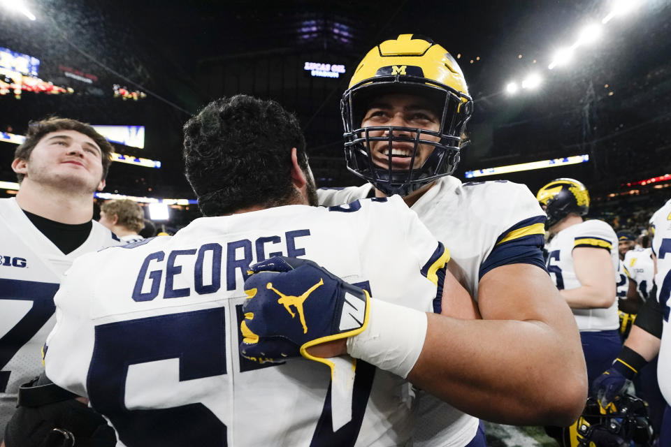 Michigan players celebrate at the end of the Big Ten championship NCAA college football game against Iowa, Saturday, Dec. 4, 2021, in Indianapolis. Michigan won 42-3. (AP Photo/AJ Mast)