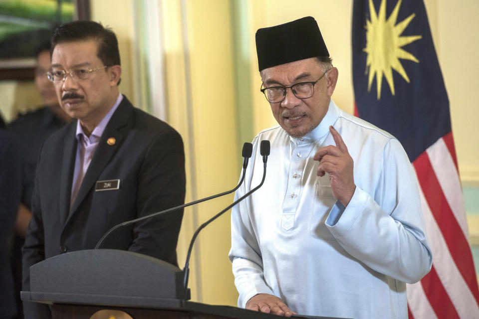 Malaysia's Prime Minister Anwar Ibrahim speaks at a press conference at the prime minister's office in Putrajaya, Malaysia, Friday, Dec. 2, 2022. New Malaysian Prime Minister Anwar Ibrahim said Friday he will also serve as finance minister as he unveiled a leaner Cabinet with many new faces in his unity government. (AP Photo/Vivian Loo)