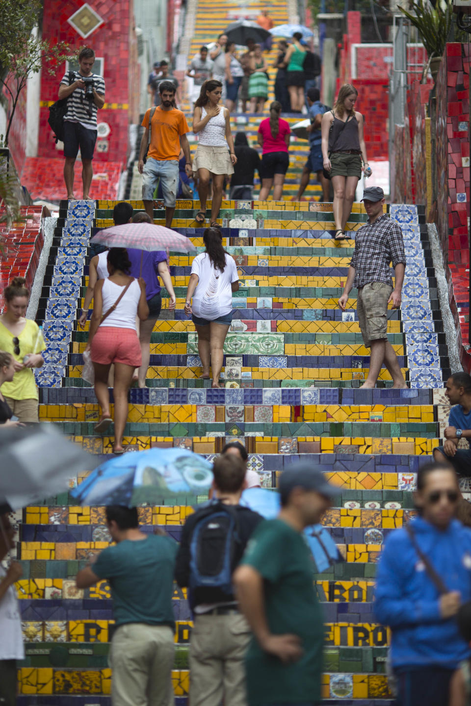 People walk up and down a stairway that was decorated by Chilean artist Jorge Selaron, which he titled the "Selaron Stairway" in Rio de Janeiro, Brazil, Thursday, Jan. 10, 2013. Selaron, an eccentric Chilean artist and longtime Rio resident who created a massive, colorful tile stairway in the bohemian Lapa district that's popular with tourists, was found dead on the stairway on Thursday. He was 54. Authorities are investigating the cause of death. (AP Photo/Felipe Dana)