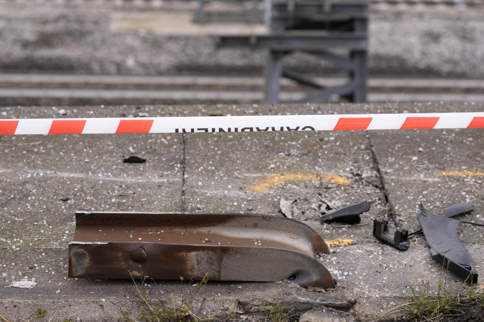 Wreckage of a damaged guardrail lies on the road at the scene of a passenger bus accident in Mestre, near the city of Venice, Italy, Wednesday, Oct. 4, 2023. The bus fell from an elevated road, late Tuesday, killing multiple people. (AP Photo/Antonio Calanni)