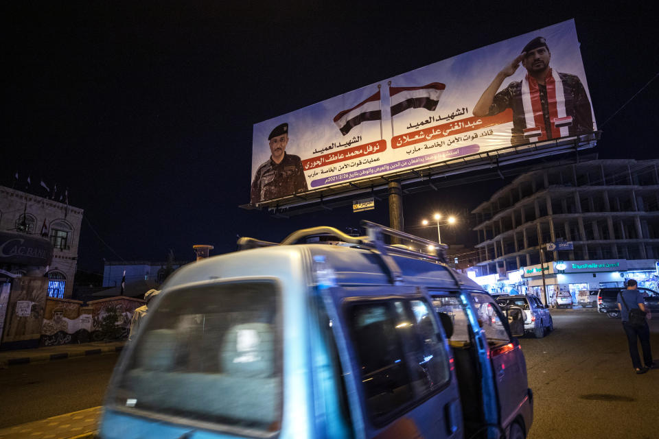 Banners show Yemeni fighters who were killed in clashes with Houthi rebels, on a street in Marib, Yemen, Sunday, June 20, 2021. On the most active front line in Yemen's long civil war, the months-long battle for the city of Marib has become a dragged-out grind with a steady stream of dead and wounded from both sides. (AP Photo/Nariman El-Mofty)