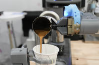 The Artly barista robot serves a drink during the CES tech show Wednesday, Jan. 10, 2024, in Las Vegas. (AP Photo/Ryan Sun)