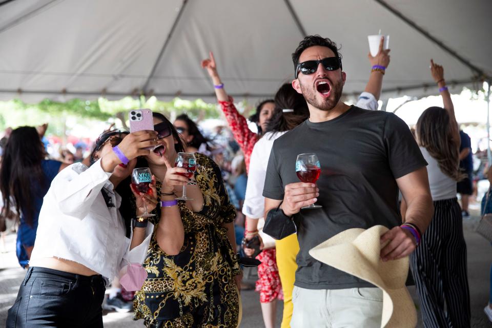 Festival-goers dance to the live music during the New Mexico Wine Festival at the Southern New Mexico State Fairgrounds  on Saturday, May 28, 2022. 