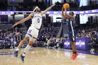 Penn State guard Kanye Clary, right, shoots against Northwestern guard Boo Buie during the first half of an NCAA college basketball game in Evanston, Ill., Sunday, Feb. 11, 2024. (AP Photo/Nam Y. Huh)