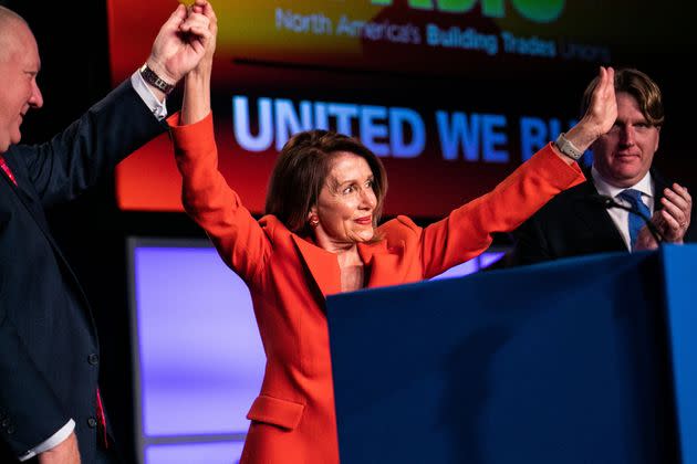 House Speaker Nancy Pelosi (D-Calif.) addresses the North America's Building Trades Unions 2019 conference. NABTU President Sean McGarvey, left, clasps her hand. (Photo: Jeenah Moon via Reuters)