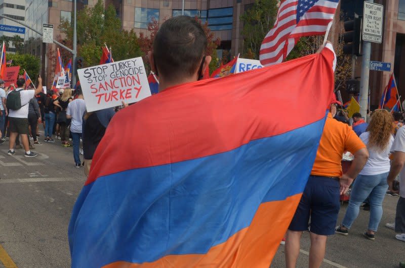 A protester draped in an Armenian flag rallies outside the Azerbaijani Consulate General offices in protest over the conflict between Armenia and Azerbaijan in Los Angeles on November 1, 2020. On September 21 1991, Armenia became the 12th Soviet republic to declare independence. File Photo by Jim Ruymen/UPI