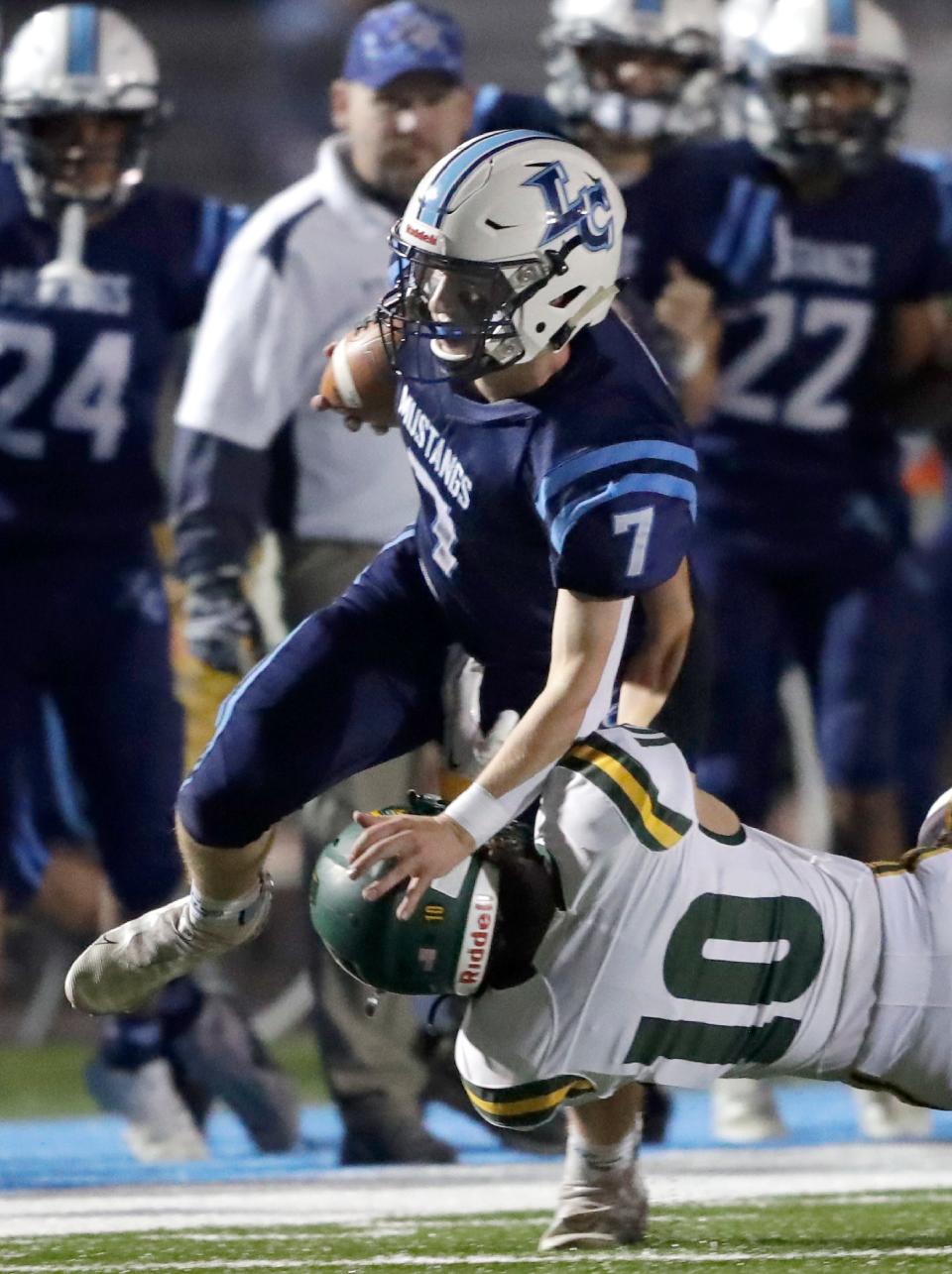 Little Chute's Drew Joten (7) runs against Freedom's Kaden Prodell during their high school football game Friday in Little Chute.