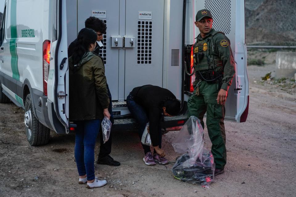 A Border Patrol agent processes a group of migrants in Sunland Park, New Mexico, on July 22, 2021. / Credit: PAUL RATJE/AFP via Getty Images