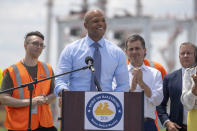 Maryland's Governor Wes Moore, second from left, speaks during a press conference to mark the full reopening of the Port of Baltimore after the collapse of the Francis Scott Key Bridge in March, Wednesday, June 12, 2024, at the Port of Baltimore in Dundalk, Md. (AP Photo/Mark Schiefelbein)