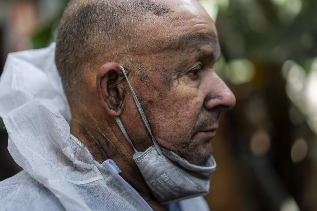 Nelson, 60, takes a break as he clears the ash from a volcano in a banana plantation on the Canary island of La Palma, Spain, Sunday, Oct. 31, 2021. The volcano that has been roaring on Spain's La Palma for over six weeks has destroyed the livelihoods of thousands of farmers and workers who grow and sell the Canary Islands banana. So far, lava flows have covered over 390 acres of land dedicated to the cultivation of the sweet yellow fruit that feeds 30% of the economic motor of the Atlantic island. (AP Photo/Emilio Morenatti)