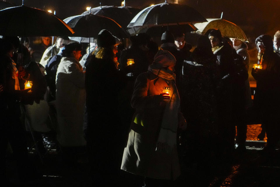 Holocaust survivors and guests take lit candles to the monument at the Birkenau Nazi death camp during a ceremony in Oswiecim, Poland, Saturday, Jan. 27, 2024. Survivors of Nazi death camps marked the 79th anniversary of the liberation of the Auschwitz-Birkenau camp during World War II in a ceremony in southern Poland.(AP Photo/Czarek Sokolowski)