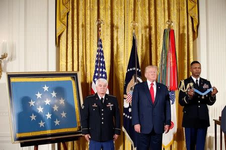 U.S. President Donald Trump stands before awarding the Medal of Honor to James McCloughan, who served in the U.S. Army during the Vietnam War, during a ceremony at the White House in Washington, U.S. July 31, 2017. REUTERS/Joshua Roberts
