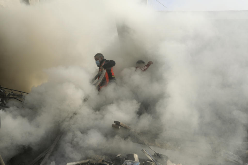 Palestinian firefighters extinguish fire caused by an Israeli airstrike in Khan Younis refugee camp, southern Gaza Strip, Tuesday, Nov. 7, 2023. (AP Photo/Mohammed Dahman)
