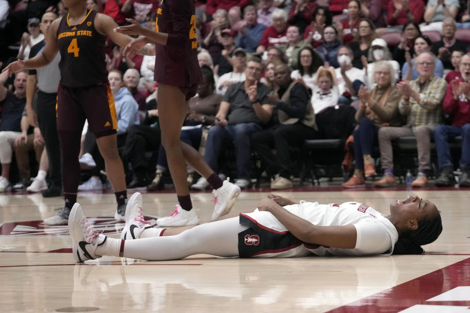 Stanford forward Nunu Agara, bottom, celebrates after scoring and being fouled against Arizona State during the second half of an NCAA college basketball game in Stanford, Calif., Sunday, Feb. 25, 2024. (AP Photo/Jeff Chiu)