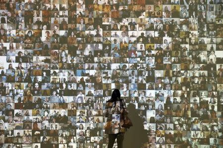 A woman looks at the audio visual installation 'Hello World!' by Christopher Baker during a press day to promote the upcoming exhibition 'From Selfie to Self-Expression' at the Saatchi Gallery in London, Britain March 30, 2017. REUTERS/Stefan Wermuth