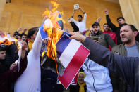 Scores of angry protesters burn the Swedish and Netherlands flags after Friday prayers outside Mohammad al-Amin Mosque to denounce the recent desecration of Islam's holy book by a far-right activists in the European countries in downtown Beirut, Lebanon, Friday, Jan. 27, 2023. Earlier this month, a far-right activist from Denmark received permission from police to stage a protest outside the Turkish Embassy in Stockholm where he burned the Quran, Islam's holy book. Days later, Edwin Wagensveld, Dutch leader of the far-right Pegida movement in the Netherlands tore pages out of a copy of the Quran near the Dutch parliament and stomped on the pages. (AP Photo/Hassan Ammar)