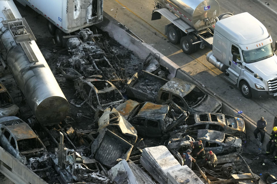 In this aerial photo, responders are seen near wreckage in the aftermath of a multi-vehicle pileup on I-55 in Manchac, La., Monday, Oct. 23, 2023. A “superfog” of smoke from south Louisiana marsh fires and dense morning fog caused multiple traffic crashes involving scores of cars. (AP Photo/Gerald Herbert)