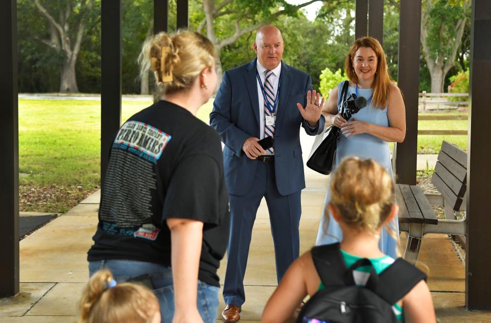 Superintendent Mark Rendell greets arriving students and parents Monday at Challenger 7 Elementary in Port St. John, joined by Janet Murnaghan, chief strategic communications officer for Brevard Public Schools. The school is now on a year-round schedule.