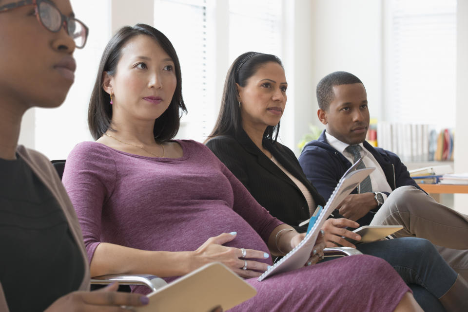 A pregnant woman in an office situation