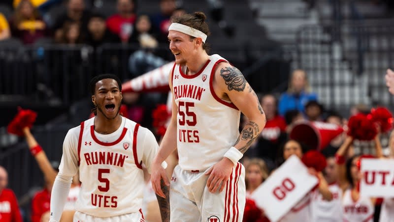 Left to right, Utah Utes guards Deivon Smith (5) and Gabe Madsen (55) smile during the first half of the game between the Utah Utes and the Arizona State Sun Devils in the first round of the 2024 Pac-12 men’s basketball tournament at the T-Mobile Arena in Las Vegas on Wednesday, March 13, 2024.