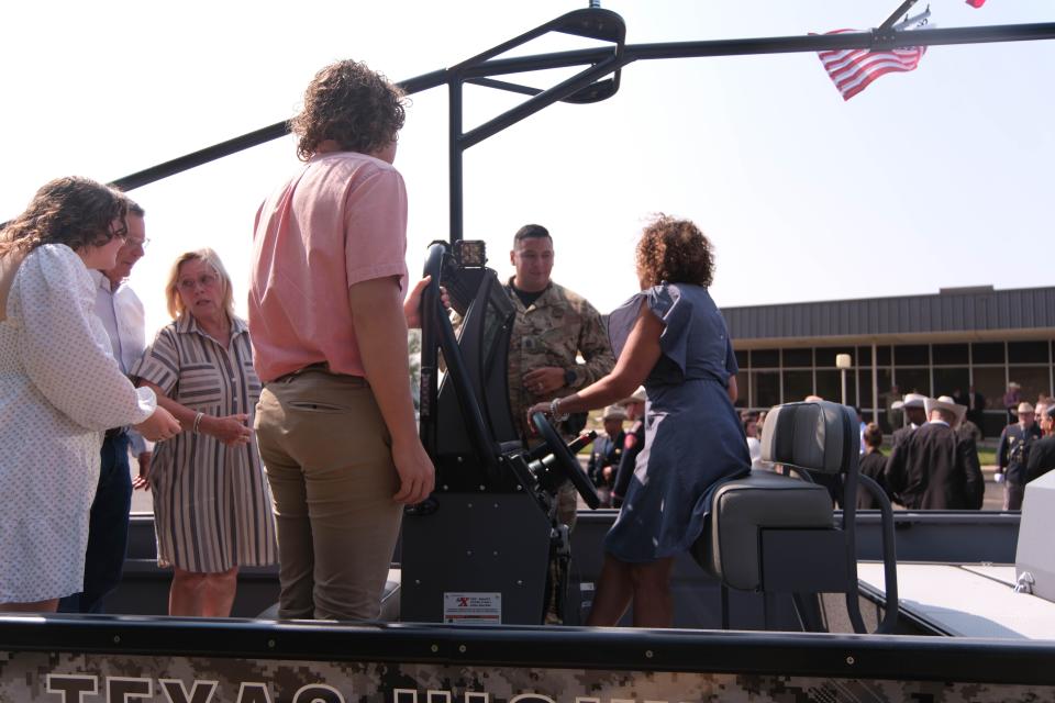 Members of Trooper Matthew Myrick's family look over the boat named in his honor Friday morning at the Texas Panhandle War Memorial Center in Amarillo.