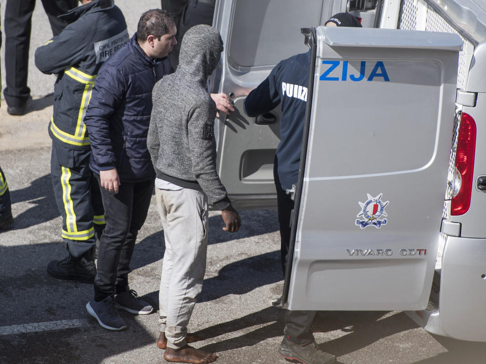 A migrant, suspected to be involved in the hijack of the Turkish oil tanker El Hiblu 1, is taken into custody in Valletta, Malta, Thursday March 28, 2019. A Maltese special operations team on Thursday boarded a tanker that had been hijacked by migrants rescued at sea, and returned control to the captain, before escorting it to a Maltese port. (AP Photo/Rene' Rossignaud)