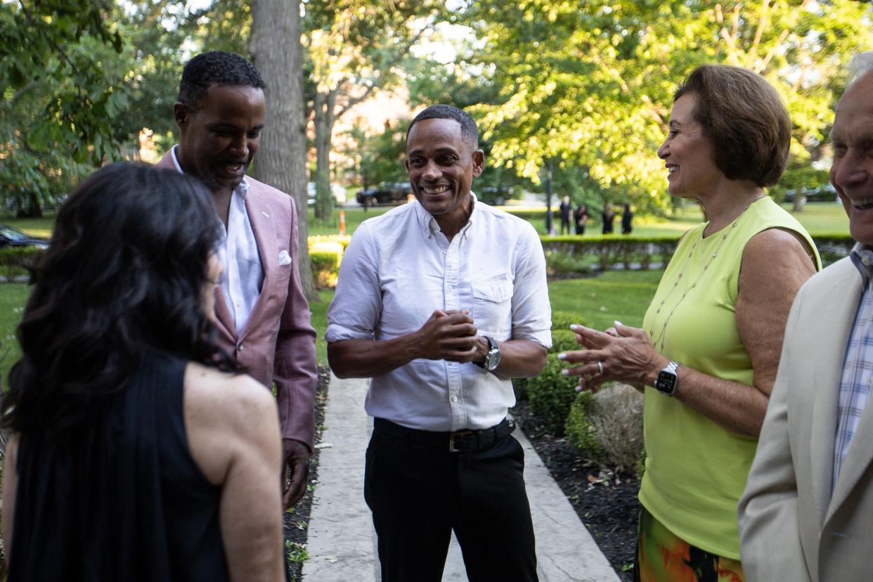 Actor and U.S. Senate candidate Hill Harper, center, talks MOCAD co-chairs Charles Boyd, left, and Lynn Gandhi, far left, and guests during MOCAD's Summer Arts Soirée at the Charles T. Fisher Mansion in Detroit on Thursday, July 13, 2023.
