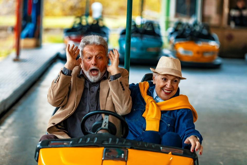 Two people enjoying a bumper car ride.