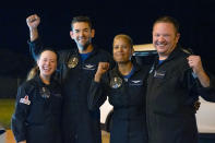 In this image released by Inspiration4, passengers aboard a SpaceX capsule, from left to right, Hayley Arceneaux, Jared Isaacman, Sian Proctor and Chris Sembroski pose after the capsule was recovered following its splashdown in the Atlantic off the Florida coast, Saturday, Sept. 18, 2021. The all-amateur crew was the first to circle the world without a professional astronaut. (John Kraus/Inspiration4 via AP)