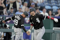 Chicago White Sox's Yasmani Grandal celebrates with third base coach Joe McEwing (99) after hitting a two-run home run during the fourth inning of a baseball game against the Kansas City Royals Monday, May 16, 2022, in Kansas City, Mo. (AP Photo/Charlie Riedel)