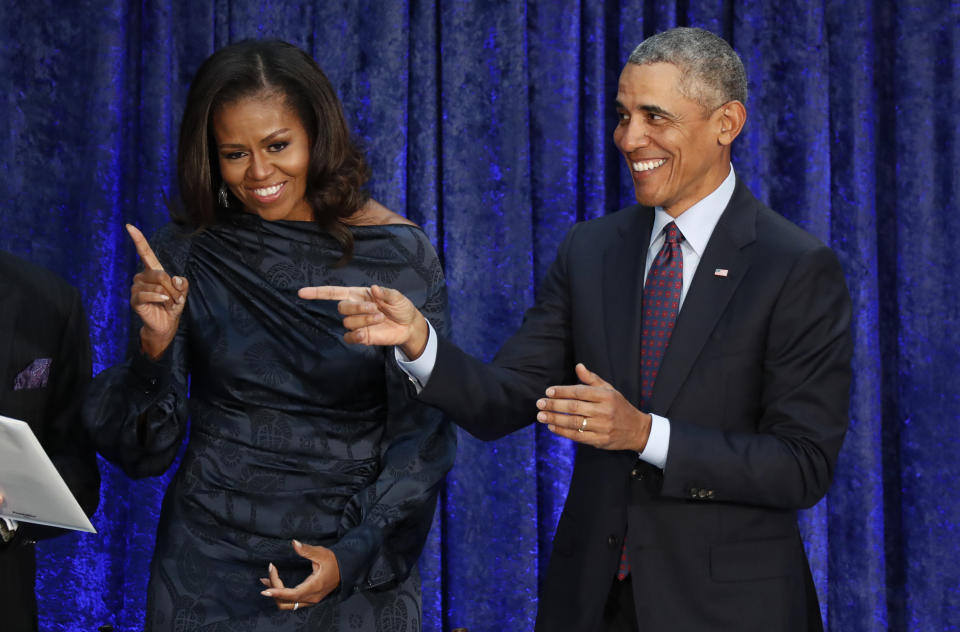 Former U.S. President Barack Obama and former first lady Michelle Obama react to the crowd during an unveiling ceremony for their portraits at the Smithsonian's National Portrait Gallery in Washington, U.S., February 12, 2018. REUTERS/Jim Bourg