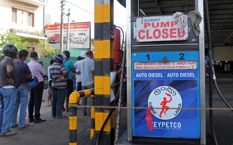 People queue for fuel - AFP