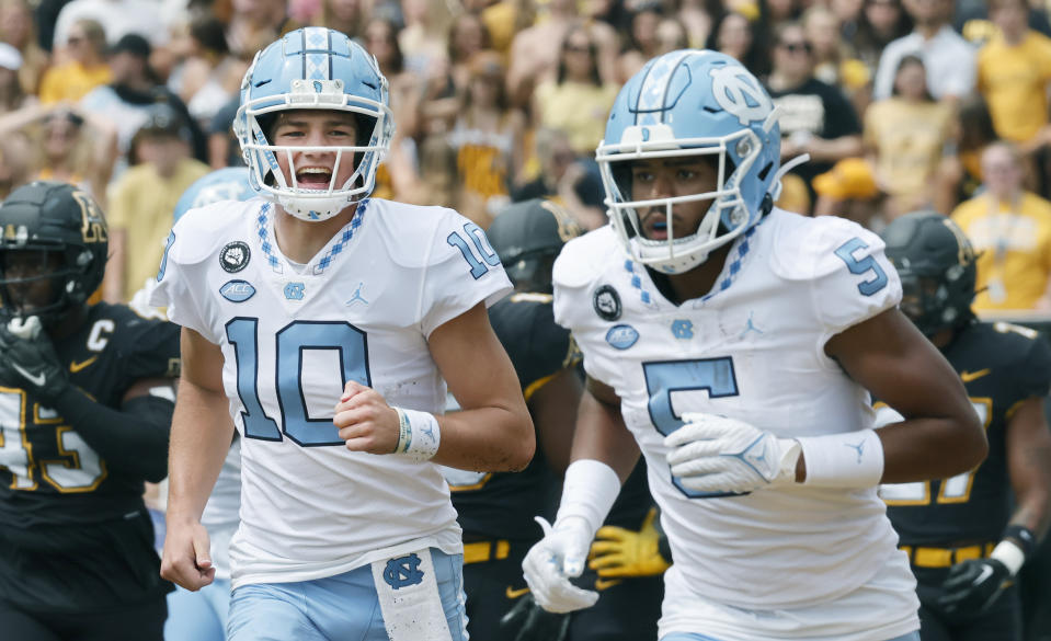 North Carolina quarterback Drake Maye (10) celebrates a touchdown with wide receiver J.J. Jones (5) during the first quarter of an NCAA college football game against the Appalachian State, Saturday Sept. 3, 2022, in Boone, N.C. (AP Photo/Reinhold Matay)