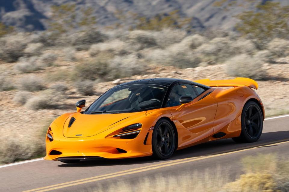 a yellow sports car on a road