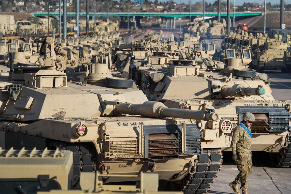 A soldier walks past a line of M1 Abrams tanks at Fort Carson in Colorado Springs, Colorado (AP)