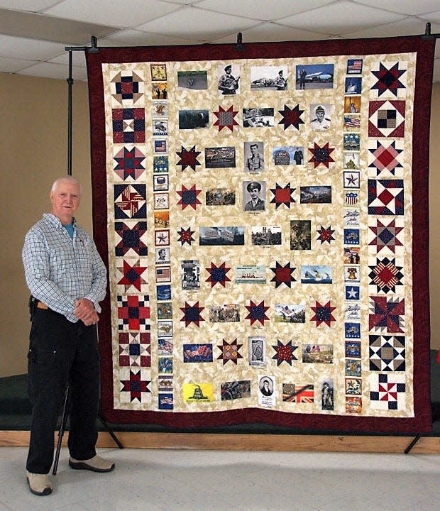 Larry Smith with the Quilt of Honor started by his wife, Dorothy, and completed after her death by the House Mountain Quilt Guild to honor his family’s 250 years of military service. Dec. 2, 2021 at Corryton Senior Center.