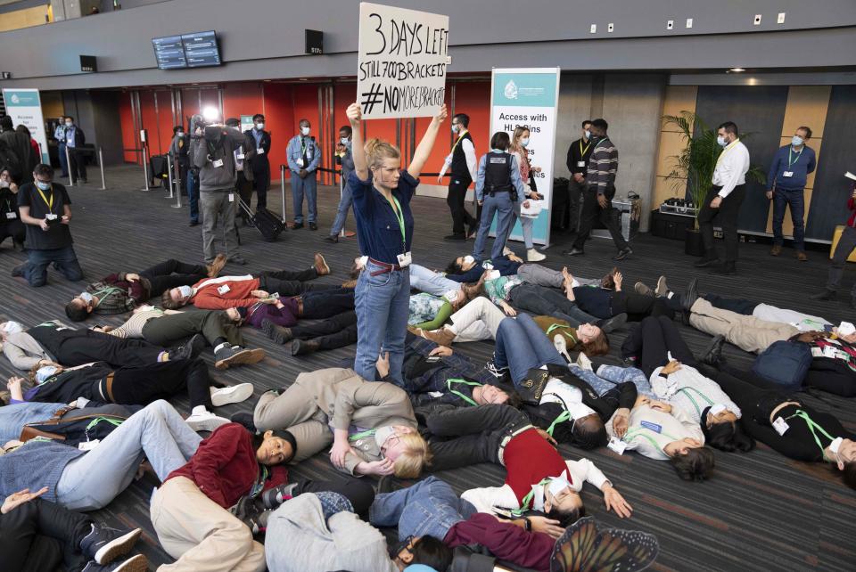 Members of the Global Youth Biodiversity Network demonstrate in the halls of the convention center at the COP15 UN conference on biodiversity in Montreal, on Friday, Dec. 16, 2022. (Paul Chiasson/The Canadian Press via AP)