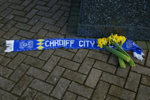 Bunches of daffodils and a Cardiff City scarf are left outside the club's stadium after news of the disappearance of the plane carrying their new signing Sala