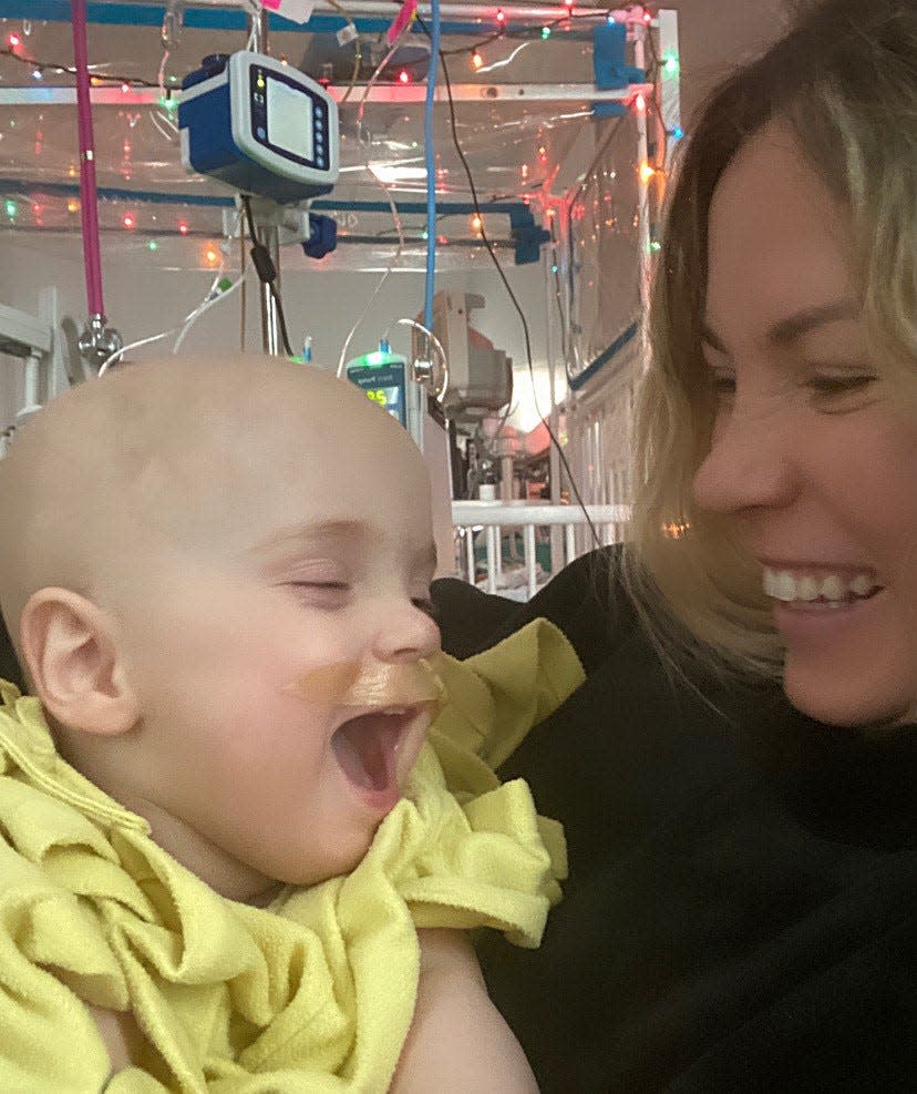 Bella Johsnon  and her mom, Shalene, share a smile at Children's Hospital. Bella continues to be a happy baby while going through treatment for brain cancer.