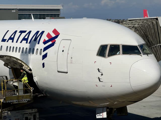 <p>DANIEL SLIM/AFP via Getty</p> A stock photo of a LATAM plane sitting at a gate at Los Angeles Airport.