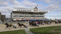 The field in race five race at the Addington Raceway in Christchurch, New Zealand, Thursday, May 28, 2020. New Zealand's financially troubled horse racing industry has reopened Thursday after being shuttered for weeks because of the coronavirus outbreak, leading the return of organized sports as the nation moves toward normality. A harness racing meeting which took place without fans at the Addington racecourse in Christchurch was the first since New Zealand went into strict lockdown on March 24. (AP Photo/Mark Baker)