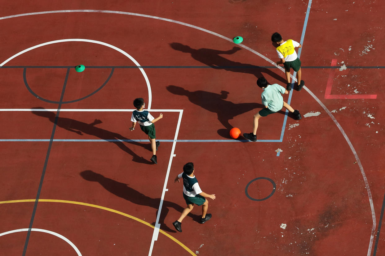 Students play ball during an extracurricular activity in school on 29 June, 2022 in Singapore. (PHOTO: NurPhoto via Getty Images)